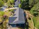 Aerial view of a landscaped yard with outdoor patio beside the gray roof and siding of a home at 522 Plantation Creek Dr, Loganville, GA 30052