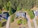 High angle shot of brick home nestled among mature trees, with expansive front and back yards at 522 Plantation Creek Dr, Loganville, GA 30052