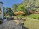 Landscaped backyard with patio, dining, grill, and shade is the perfect place to entertain or simply kick back and relax at 522 Plantation Creek Dr, Loganville, GA 30052