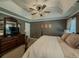 Comfortable primary bedroom with tray ceiling, soft lighting, and carpeted floors at 522 Plantation Creek Dr, Loganville, GA 30052