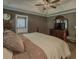 Comfortable primary bedroom with tray ceiling, soft lighting, and ensuite bathroom at 522 Plantation Creek Dr, Loganville, GA 30052