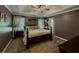 Comfortable primary bedroom with tray ceiling, soft lighting, and carpeted floors at 522 Plantation Creek Dr, Loganville, GA 30052
