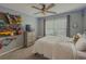 Bright bedroom with decor, ceiling fan, and a large window that lets in natural light at 522 Plantation Creek Dr, Loganville, GA 30052