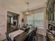Cozy dining room with dark table and seating for four, adjacent to the living room, with modern lighting at 522 Plantation Creek Dr, Loganville, GA 30052