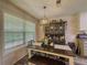 Casual dining room featuring a modern light fixture and a table set for a meal, with plenty of natural light at 522 Plantation Creek Dr, Loganville, GA 30052