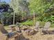 Outdoor fire pit area provides a cozy retreat for gatherings, with seating for four and mature trees surrounding at 522 Plantation Creek Dr, Loganville, GA 30052