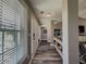Inviting hallway with wood floors, leading to other areas of the home, with a window showcasing natural light at 522 Plantation Creek Dr, Loganville, GA 30052