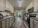 Well-appointed kitchen with stainless steel appliances, ample countertop space, and a view into the dining area at 522 Plantation Creek Dr, Loganville, GA 30052