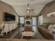 Spacious living room with vaulted ceilings, a brick fireplace, and a large television for Gathering entertainment at 522 Plantation Creek Dr, Loganville, GA 30052