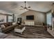 Large, comfortable living room with stylish decor, vaulted ceiling, and wood-look floors perfect for relaxing at 522 Plantation Creek Dr, Loganville, GA 30052