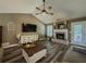 Bright living room featuring a brick fireplace, modern furnishings, and ample natural light through large windows at 522 Plantation Creek Dr, Loganville, GA 30052