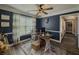 Inviting home office with wainscotting, modern ceiling fan, plank flooring and natural light at 522 Plantation Creek Dr, Loganville, GA 30052