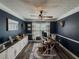 Home office with modern ceiling fan, wainscotting, plank flooring, built-ins and natural light at 522 Plantation Creek Dr, Loganville, GA 30052