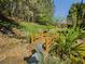 Backyard water feature with a small bridge set amongst mature trees and lush greenery makes you feel one with nature at 522 Plantation Creek Dr, Loganville, GA 30052