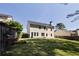 Back exterior view of home showing large, grassy yard with wood fencing at 1553 Pinebreeze Dr, Marietta, GA 30062