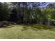 Large, grassy back yard with a wood fence and mature trees at 1553 Pinebreeze Dr, Marietta, GA 30062