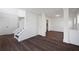 Open-concept dining area with hardwood floors, white trim, and an adjacent staircase at 1553 Pinebreeze Dr, Marietta, GA 30062