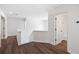 Hallway with wood floors with stairs and access to a bathroom at 1553 Pinebreeze Dr, Marietta, GA 30062