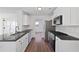 Bright kitchen featuring stainless steel appliances, granite countertops, and ample white cabinetry at 1553 Pinebreeze Dr, Marietta, GA 30062