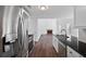 Modern kitchen boasts stainless steel appliances, granite countertops, and leads to the living room at 1553 Pinebreeze Dr, Marietta, GA 30062