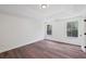 Main bedroom with light walls, wood-look floors and 2 windows at 1553 Pinebreeze Dr, Marietta, GA 30062