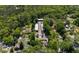 Aerial view of a residential area featuring townhouses nestled among mature trees and quiet streets at 305 Stonecliff Ct, Stone Mountain, GA 30083
