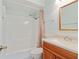 Clean bathroom with shower and tub combo, vanity with wood cabinets, and a mirror at 305 Stonecliff Ct, Stone Mountain, GA 30083