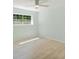 Bright bedroom with a large window, ceiling fan and light colored flooring at 305 Stonecliff Ct, Stone Mountain, GA 30083