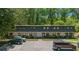 Townhouse complex showcasing a well-manicured exterior, with ample parking and lush greenery surrounding the property at 305 Stonecliff Ct, Stone Mountain, GA 30083