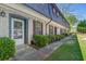 Townhouse with brick facade, classic shutters, and well-maintained lawn leading to a cozy entrance at 305 Stonecliff Ct, Stone Mountain, GA 30083