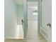 Hallway with stairs leading to a bright room with light-colored floors and a window at 305 Stonecliff Ct, Stone Mountain, GA 30083