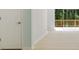 Living area with hardwood floors, neutral paint, and access to a private outdoor deck with natural views at 305 Stonecliff Ct, Stone Mountain, GA 30083