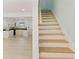 Kitchen featuring white cabinets, wood floors, and a view of the stairs at 305 Stonecliff Ct, Stone Mountain, GA 30083