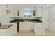 Well-lit kitchen boasts white cabinetry, brown countertops, and a window over the sink at 305 Stonecliff Ct, Stone Mountain, GA 30083