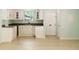 Cozy kitchen featuring all white cabinets and wood grain flooring at 305 Stonecliff Ct, Stone Mountain, GA 30083