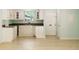 Cozy kitchen with white cabinetry, dark countertops, and modern flooring; perfect for intimate meal preparation at 305 Stonecliff Ct, Stone Mountain, GA 30083