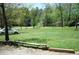 Expansive front yard with lush green grass, mature trees, and a glimpse of the charming home in the background at 31 Dogwood Nw Ln, Cartersville, GA 30121
