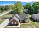 Aerial view of a brick home with a long driveway, a well-manicured lawn, and mature trees at 1337 Highfield Dr, Lawrenceville, GA 30043