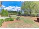 Lush backyard with manicured lawn, trimmed bushes, a cozy bench, and a patio area, perfect for relaxation and gatherings at 1337 Highfield Dr, Lawrenceville, GA 30043