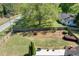 A spacious fenced backyard with a large tree, garden area and a bench, perfect for outdoor relaxation and entertainment at 1337 Highfield Dr, Lawrenceville, GA 30043