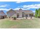 Exterior view of the back of the house with a patio, trimmed shrubs, and a fenced yard for outdoor living and privacy at 1337 Highfield Dr, Lawrenceville, GA 30043