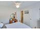 Bright bedroom featuring a window, a ceiling fan, a bed, and a vanity with storage at 1337 Highfield Dr, Lawrenceville, GA 30043