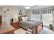 Cozy bedroom with neutral tones, a decorative headboard, a ceiling fan, and two windows at 1337 Highfield Dr, Lawrenceville, GA 30043