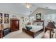 Vaulted ceiling Primary bedroom with a bed, dresser, side tables, and a doorway to the en suite bath at 1337 Highfield Dr, Lawrenceville, GA 30043