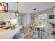 Inviting dining room with a wood table, six chairs, and stylish lighting fixtures and wood floors at 1337 Highfield Dr, Lawrenceville, GA 30043