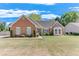 Charming brick home featuring a well-manicured front yard and lush landscaping at 1337 Highfield Dr, Lawrenceville, GA 30043