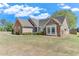 Well-maintained single-story home with a brick facade, a manicured lawn, and mature trees at 1337 Highfield Dr, Lawrenceville, GA 30043