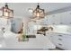 Bright kitchen with center island, white cabinets, and modern pendant lighting at 1337 Highfield Dr, Lawrenceville, GA 30043