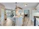 Kitchen island with barstool seating next to breakfast area at 1337 Highfield Dr, Lawrenceville, GA 30043