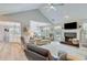 Comfortable living room with vaulted ceiling, fireplace, and views of the dining area at 1337 Highfield Dr, Lawrenceville, GA 30043